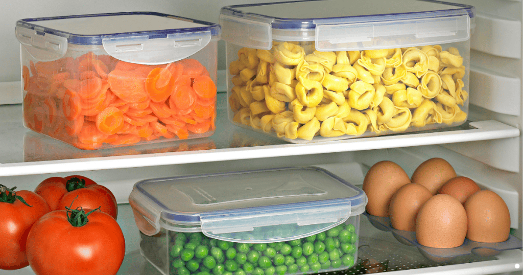 pasta, peas, and carrots in containers in fridge