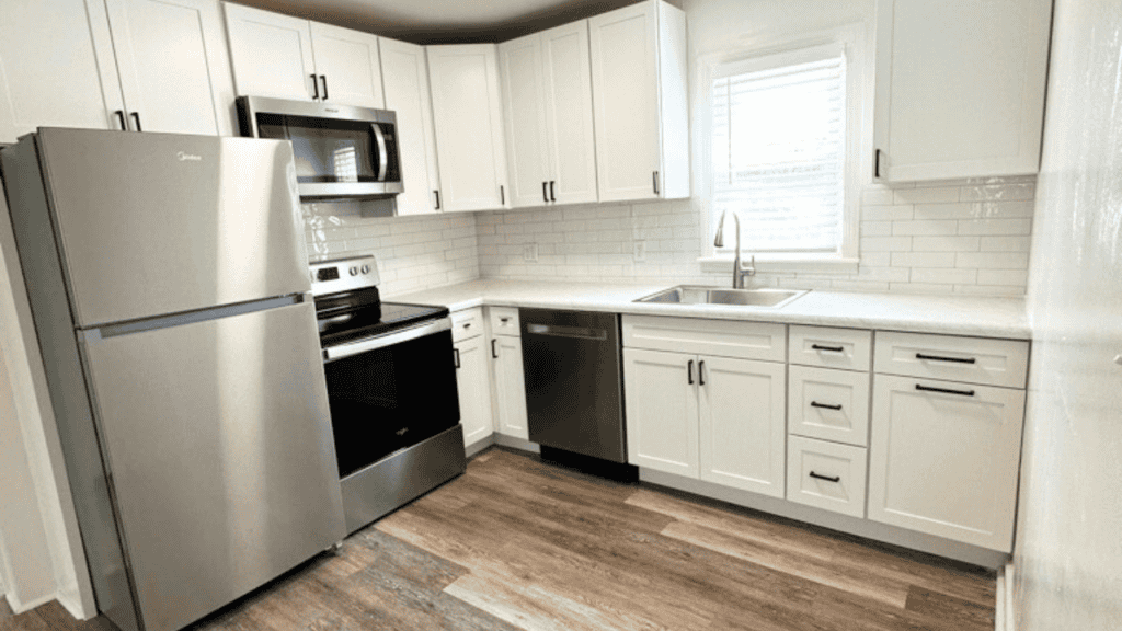 small white kitchen with stainless steel appliances