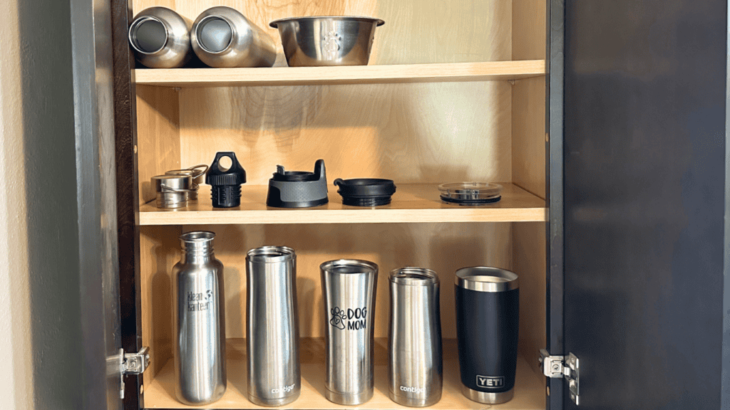 water bottles with lids in a kitchen cabinet