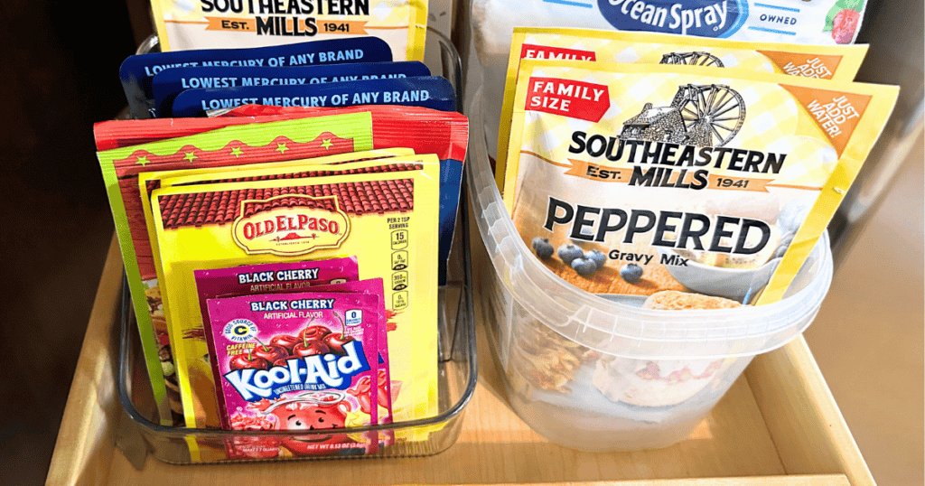 food packets organized in a plastic container and a dishwasher pod container