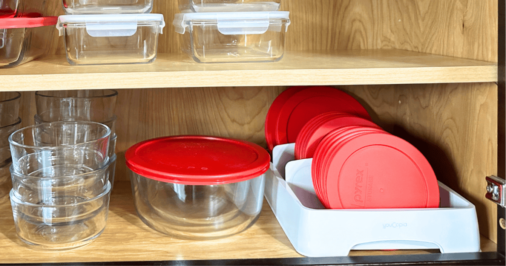 White lid organizer holding red lids for storage bowls