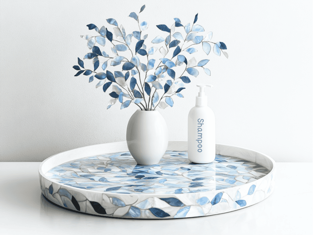 Blue and white lazy susan containing a vase of flowers and a bottle of shampoo