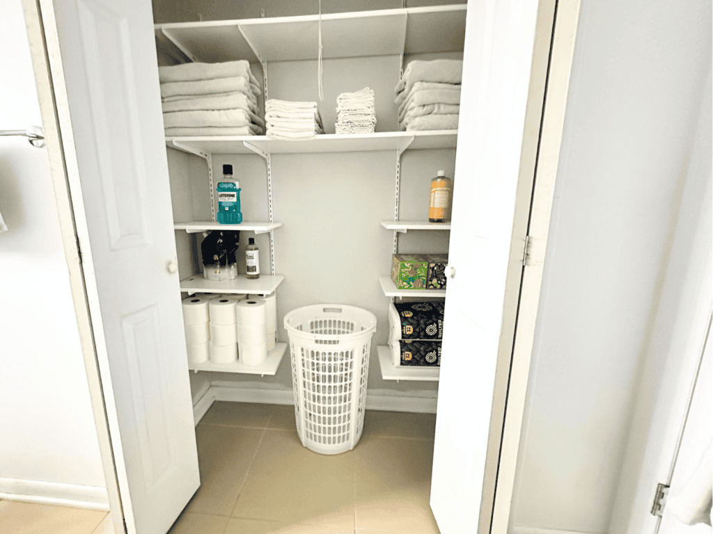 Small bathroom closet with adjustable shelves