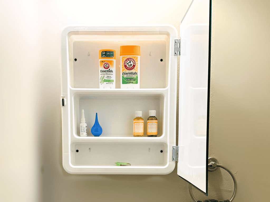 Three shelf medicine cabinet in a small bathroom