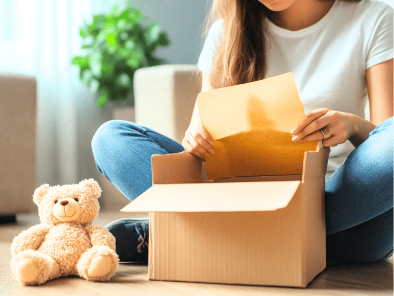 Woman putting stuff in a box to donate