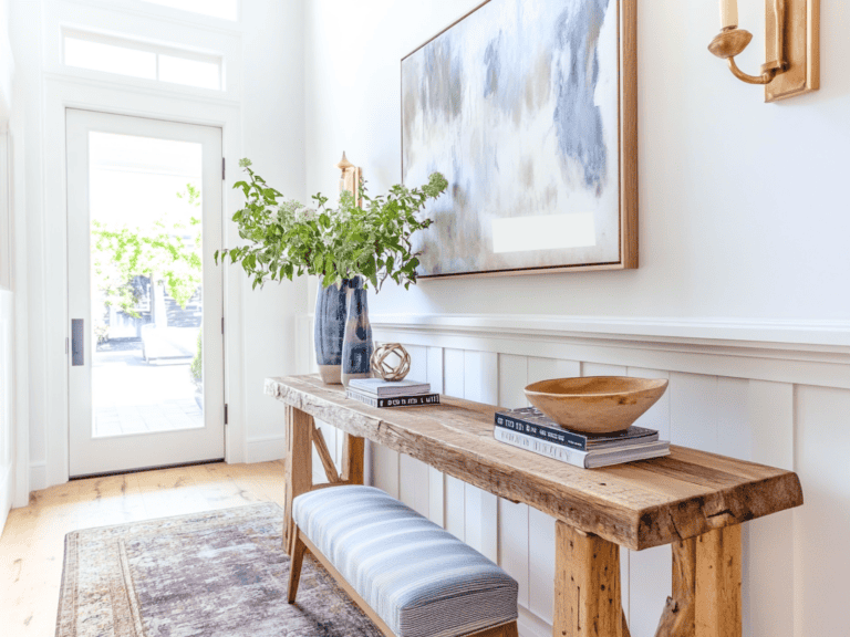 Glass entry door and a entryway with a small table, bench and picture