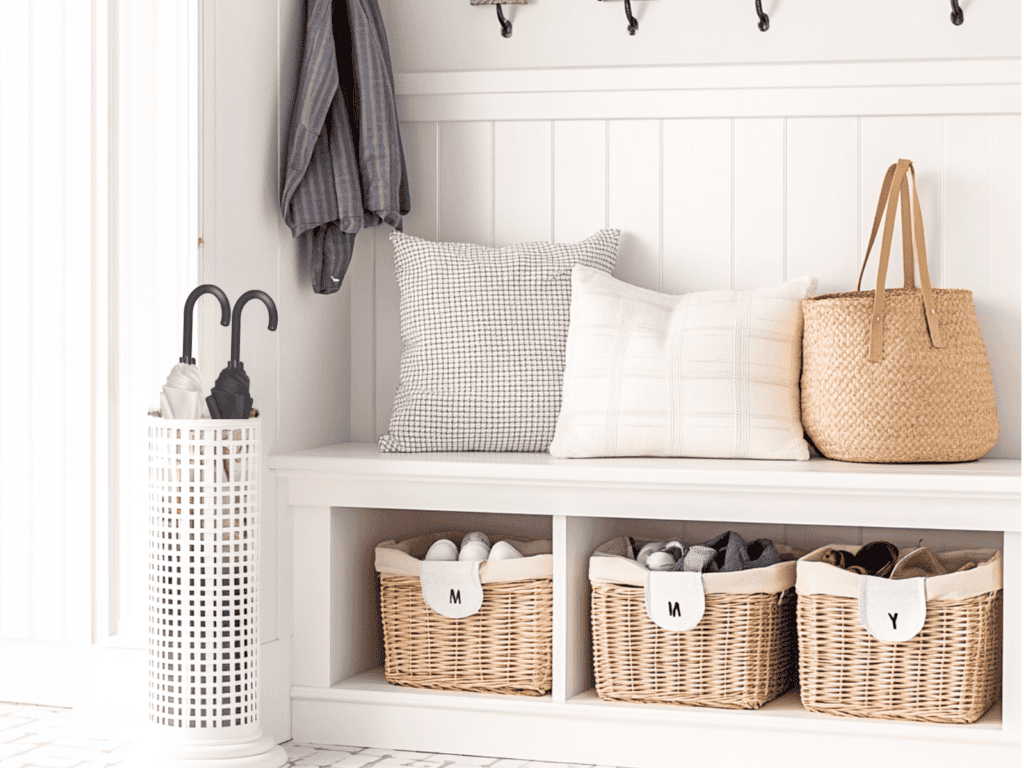 Entryway bench with shelf with hooks and an umbrella stand with two umbrellas