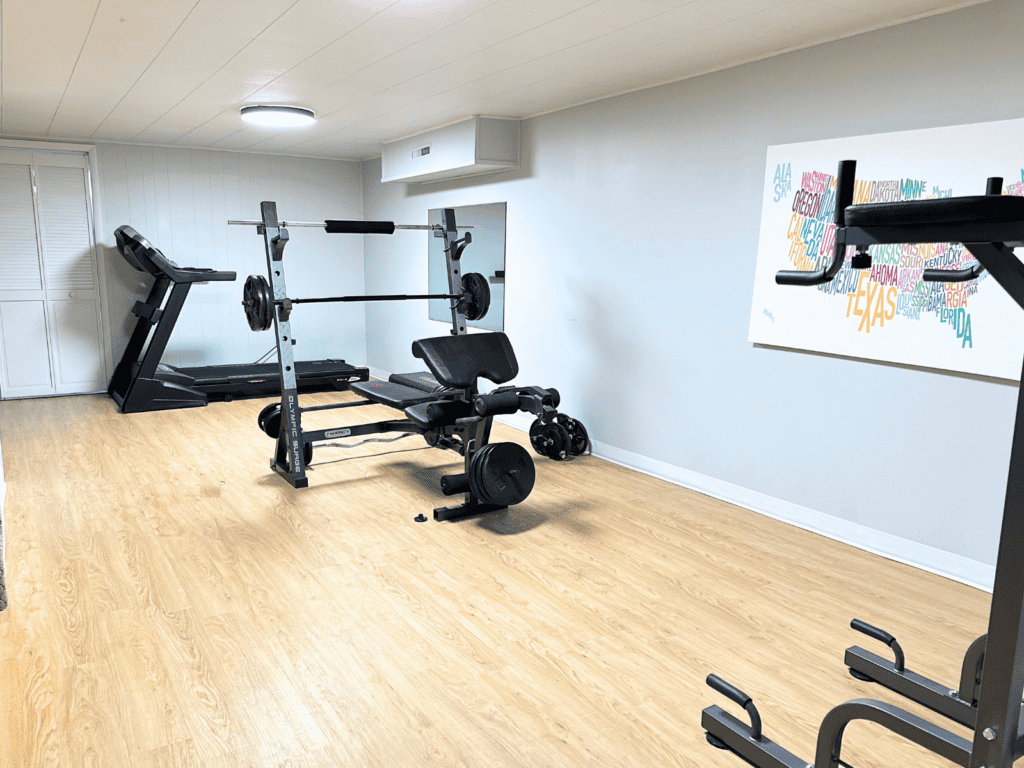 Weight bench and treadmill in my home gym