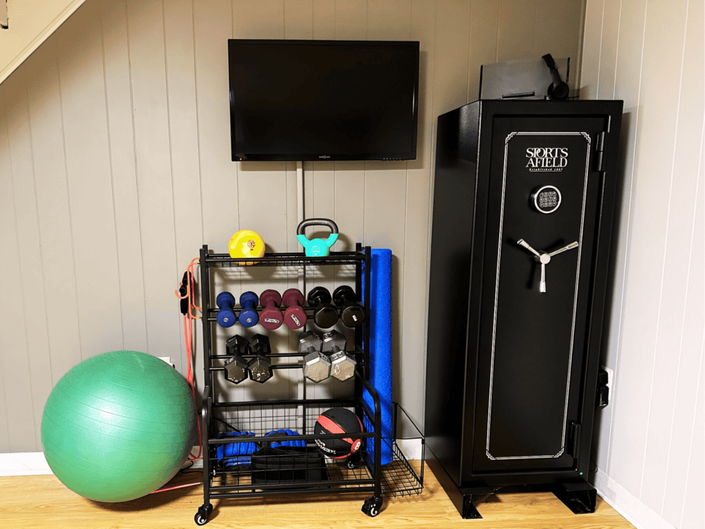 Weight rack with dumbbells, yoga mat, kettlebell and a ball.