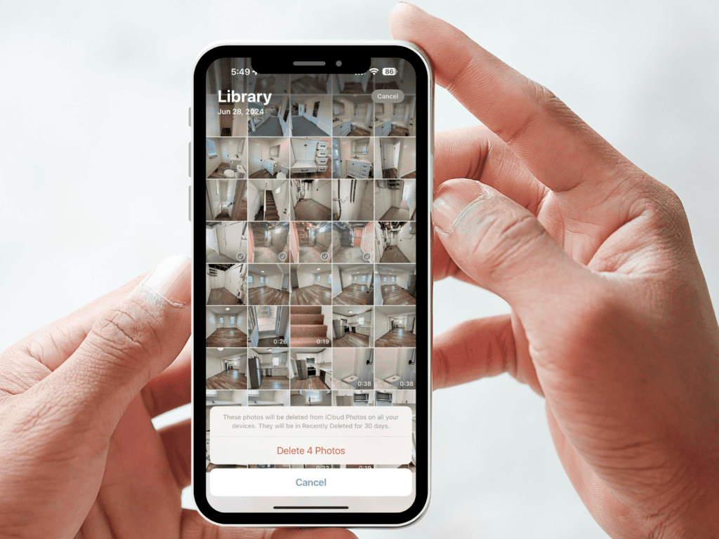 Hands holding a smartphone displaying duplicate photos and a prompt to delete them.