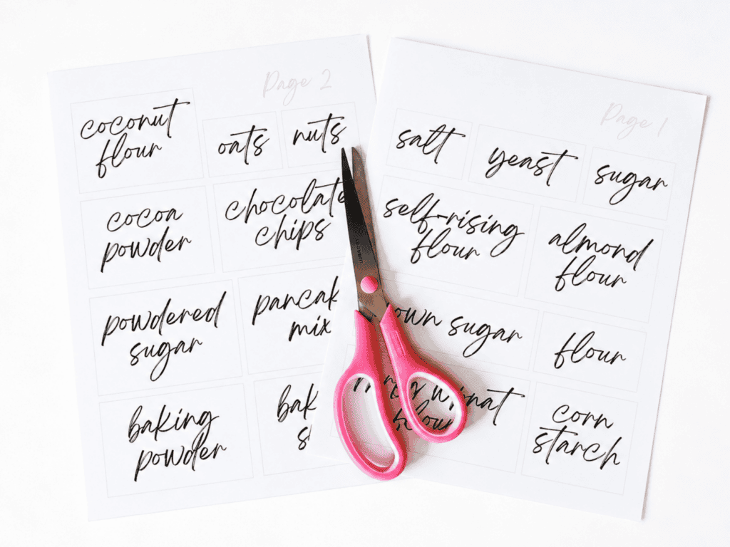 Two pages of pantry labels with a pair of pink scissors on top of them.