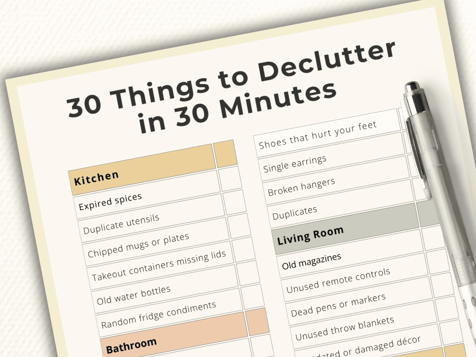 Flat-lay of a printable decluttering checklist showing kitchen, bathroom, and living room items to declutter in 30 minutes.
